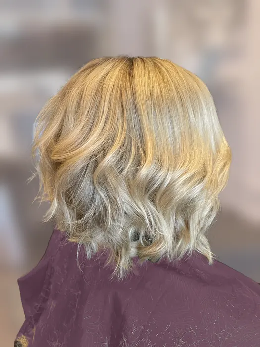 Beige blonde textured bob with soft waves and a root shadow