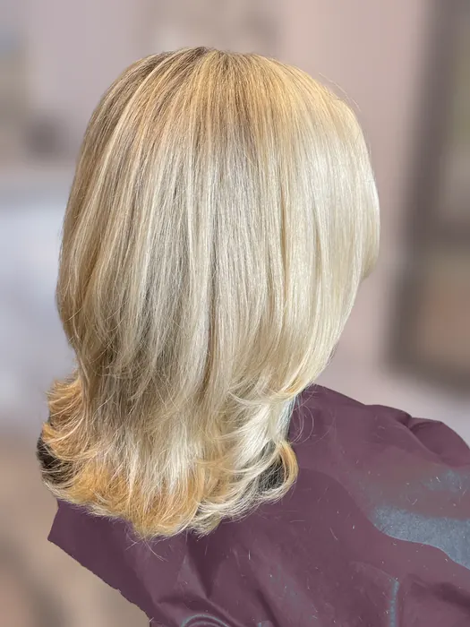 Bright blonde highlights on shoulder-length layers