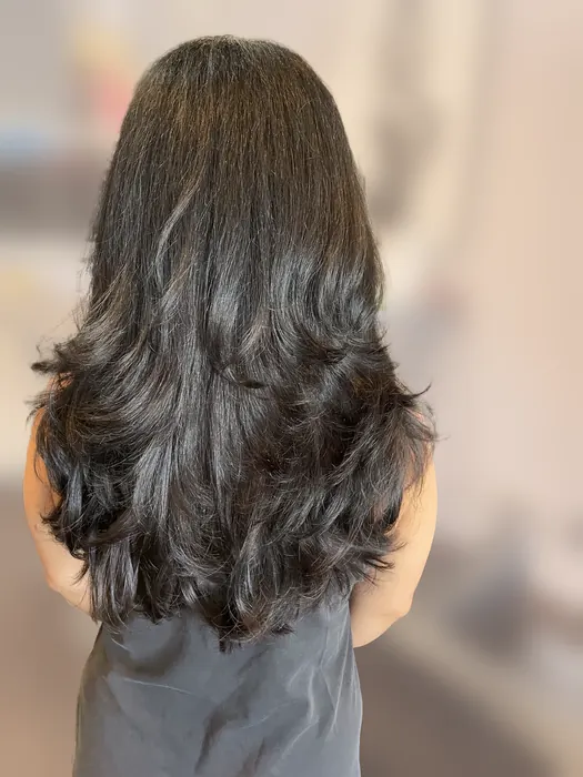 Long dark hair with a layered women’s haircut